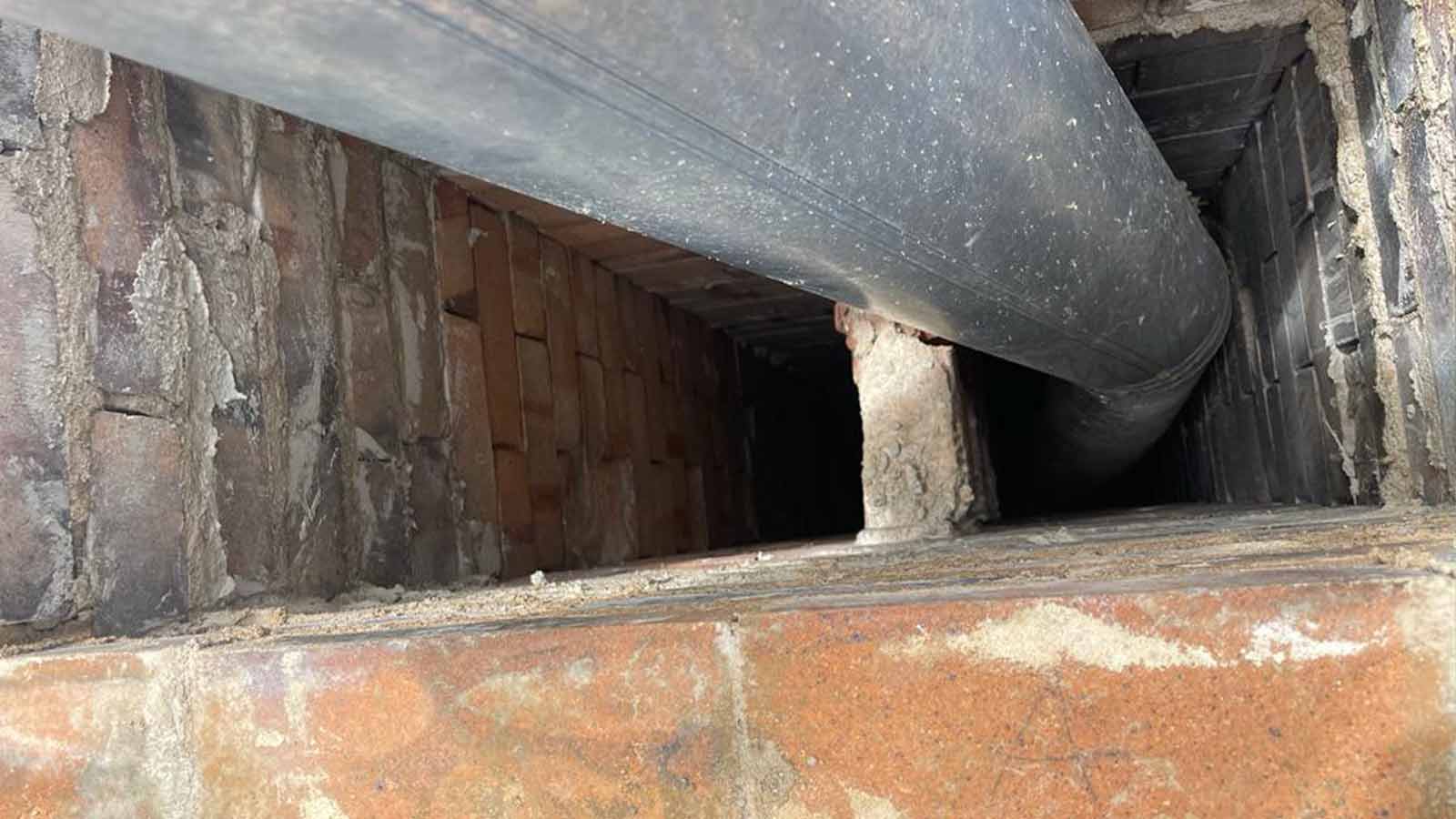 Adam Chimney Sweep technician cleaning a Denver chimney flue